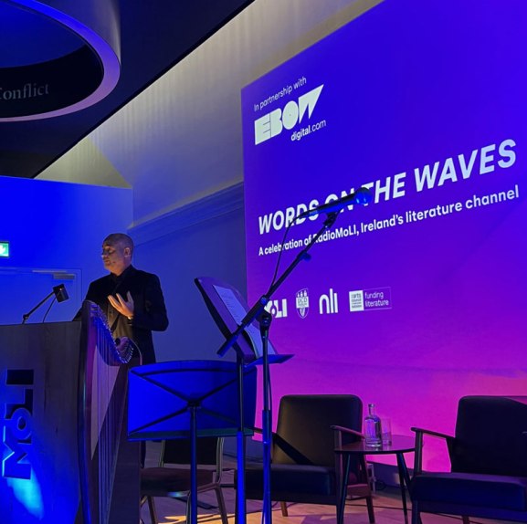David Douglas, MD of Ebow Digital, standing at a MOLI-branded podium giving a speech.