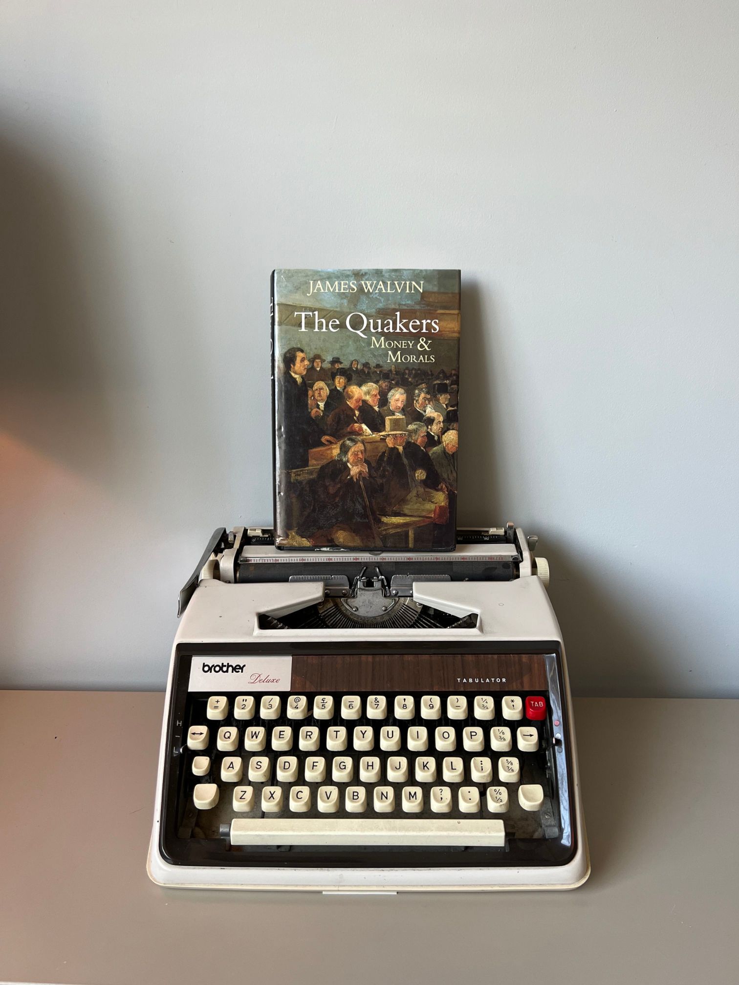 Image of the book The Quakers Money and Morals on top on an old typewriter