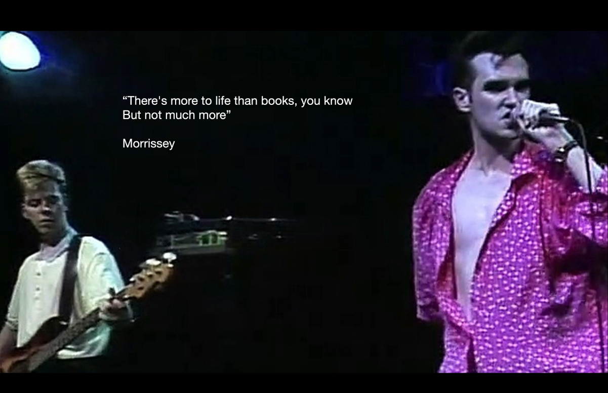 Picture of The Smiths with Morrissey at the front and Andy Rourke at the left.