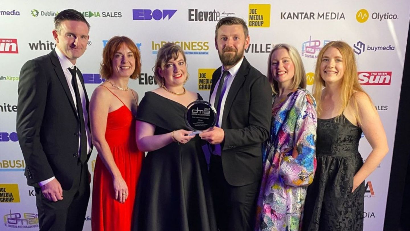 Picture of team with happy client winning awards
